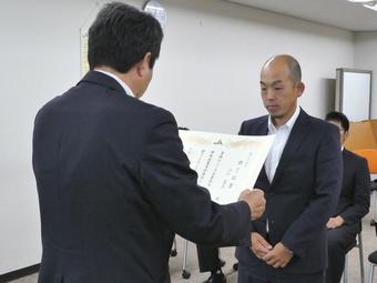 桑田県本部長（左）から修了証書を受け取る１０期生（右）の内容を表示
