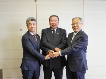 握手を交わす川崎社長(左)、小林組合長(中央)、西村県本部長(右)の内容を表示