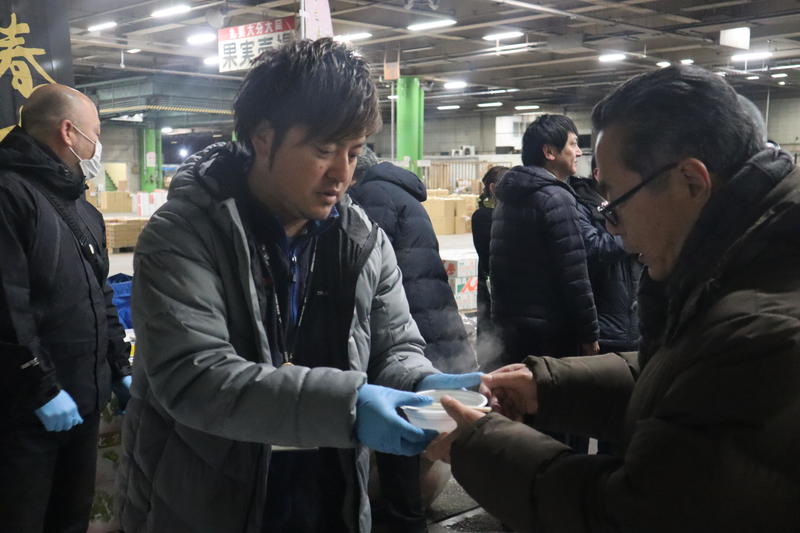 ◆試食の七草がゆを配布する園芸販売課 西田剛調査役の内容を表示