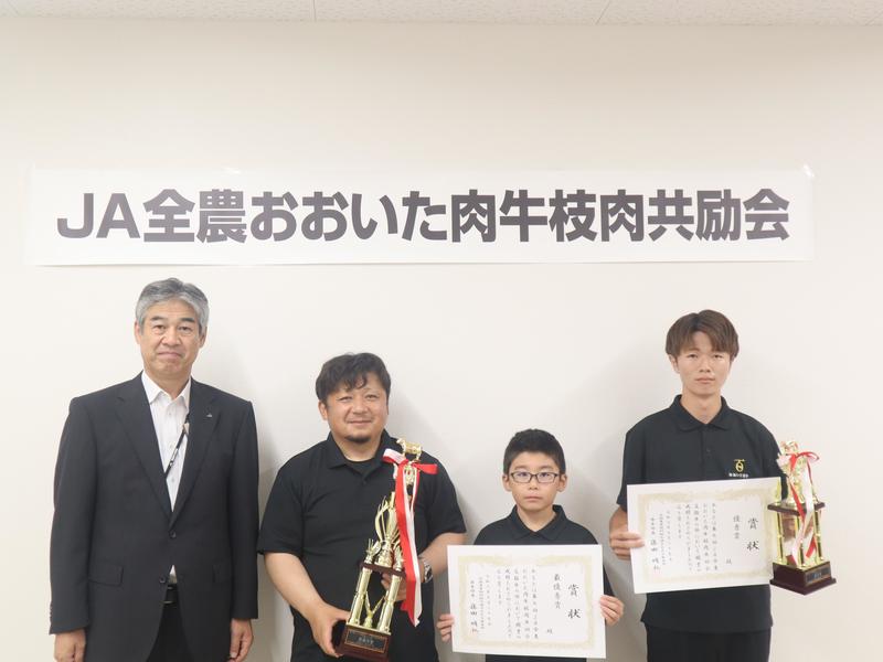 ◆日野副本部長(㊧)と交雑牛の部受賞者の内容を表示