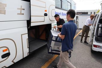 専用ボックスをバスのトランクスペースに積み込む山梨県本部職員の内容を表示