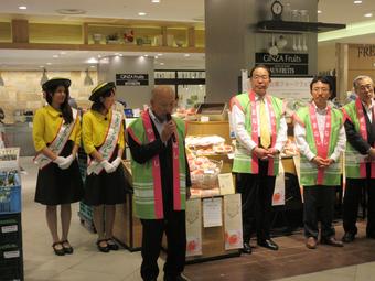 「三越銀座店」の青果売場で、来店者に向かってあいさつする關本会長の内容を表示